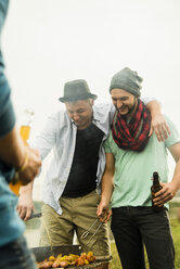 Group of friends drinking beer and having a barbecue - UUF001861