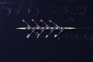 Elevated view of female's rowing eight in water - ZE000452
