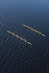 Elevated view of two rowing eights in water - ZEF000457