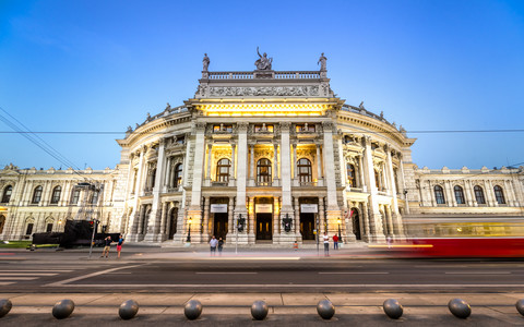 Austria, Vienna, Burgtheater with passing tramway at blue hour stock photo