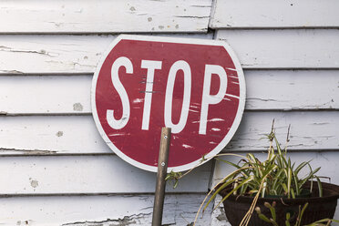 New Zealand, South Island, Ross, New Zealand, stop sign leaning at wooden facade - WV000717
