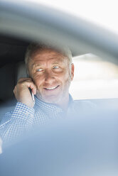 Businessman with cell phone in car - UUF001926