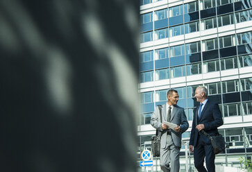 Two businessmen talking outside office building - UUF001946