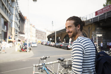 Germany, Berlin, Young man waiting for his girl friend - FKF000645