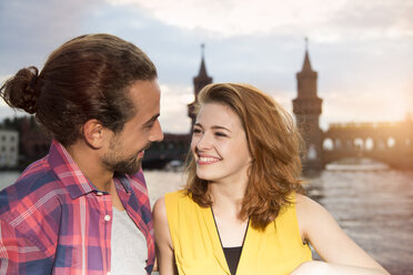 Germany, Berlin, Young couple enjoying sunset at Spree river - FKF000673