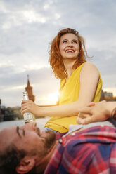 Germany, Berlin, Young couple enjoying sunset at Spree river - FKF000679