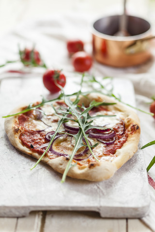 Homemade pizza on chopping board stock photo