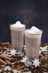 Two glasses of hot chocolate with cream, cinnamon stars and cinnamon sticks on cloth - CZF000168