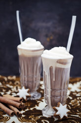 Two glasses of hot chocolate with cream, cinnamon stars and cinnamon sticks on cloth - CZF000169