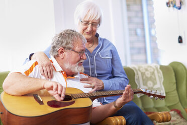 Senior man with wife at home playing guitar - ZEF001101