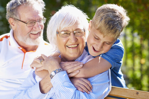 Grandson hugging grandmother in park - ZEF001115