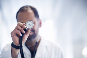 Germany, Freiburg, Doctor holding stethoscope - SGF000849