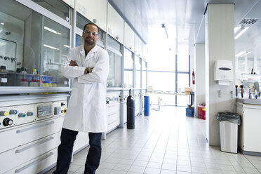 Chemist with crossed arms standing at a laboratory - SGF000861