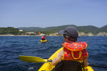 Spain, Balearic Islands, Ibiza, Es Figueral, young boy sitting in a kayak - TKF000409