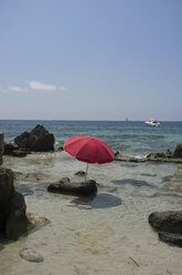 Spain, Balearic Islands, Ibiza, Las Salinas, sunshade on a rock - TKF000401