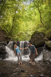 Deutschland, Rheinland-Pfalz, Moselsteig, Ehrbachklamm, Paar Hand in Hand am Wasserfall - PAF001000