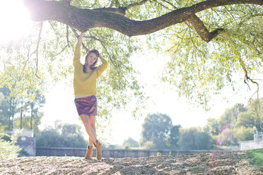 Young woman wearing knit pullover and mini skirt - MAEF009193