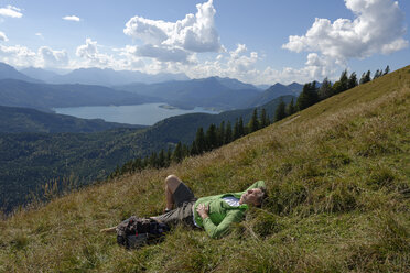 Germany, Bavaria, Upper Bavaria, Toelzer Land, Hiker at the Hirschhoernlkopf Jachenau, Walchensee lake in the background - LBF000971