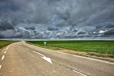 Spain, Province of Zamora, country road under cloudy sky - DSGF000807