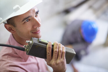 Construction worker talking on two-way radio - ZEF001837