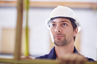 Construction worker measuring wood frame - ZEF001818