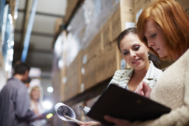 Two women with clipboard in warehouse - ZEF001442