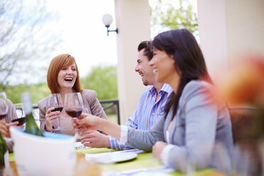 Friends drinking red wine on loggia - ZEF001471