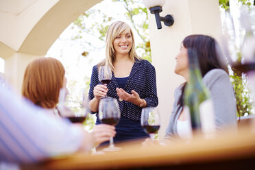 Friends drinking red wine on loggia - ZEF001472