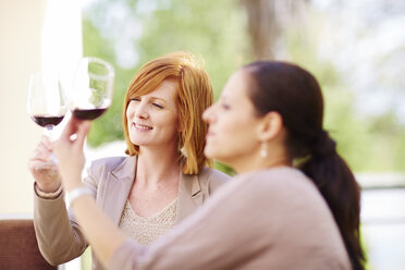 Two women examining red wine - ZEF001466