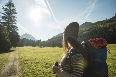 Portrait of happy young woman hiking in the mountains Stock Photo