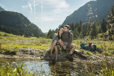 Austria, Tyrol, Tannheimer Tal, two happy young hikers relaxing - UUF002135