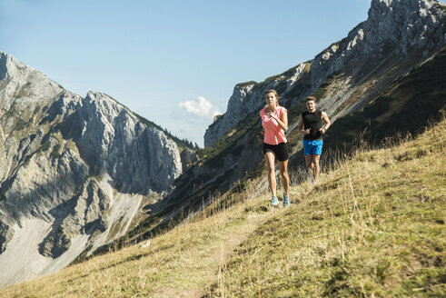 Österreich, Tirol, Tannheimer Tal, junges Paar joggt in den Bergen - UUF002140