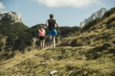 Austria, Tyrol, Tannheim Valley, young couple jogging in mountains - UUF002067