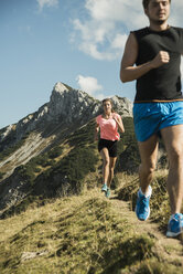 Österreich, Tirol, Tannheimer Tal, junges Paar joggt in den Bergen - UUF002068