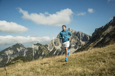 Austria, Tyrol, Tannheim Valley, young man jogging in mountains - UUF002086