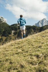 Austria, Tyrol, Tannheim Valley, young man jogging in mountains - UUF002089