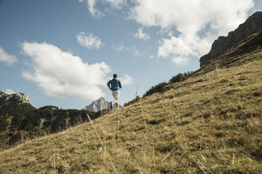 Austria, Tyrol, Tannheim Valley, young man jogging in mountains - UUF002092