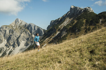 Austria, Tyrol, Tannheim Valley, young man jogging in mountains - UUF002093