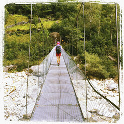 Switzerland, Val Verzasca, woman on bridge - GWF003239