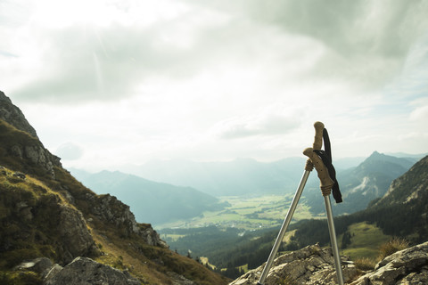 Austria, Tyrol, Tannheimer Tal, hiking poles in mountainscape stock photo