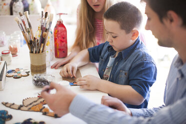 Boy tinkering in art class - ZEF001413