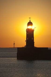 Germany, Bremen, Bremerhaven, Lighthouse on the pier at sunset - OLEF000042