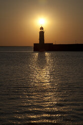 Germany, Bremen, Bremerhaven, Lighthouse on the pier at sunset - OLEF000038