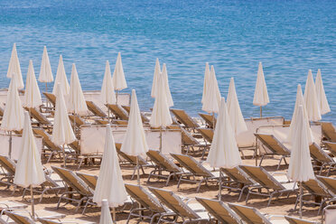 France, Cote d'Azur, Cannes, sun loungers and beach umbrellas on beach - WDF002716