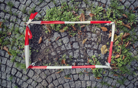 Germany, fixed barrier tape arround damaged cobblestone pavement stock photo