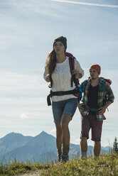 Austria, Tyrol, Tannheimer Tal, young couple hiking on mountain trail - UUF002200