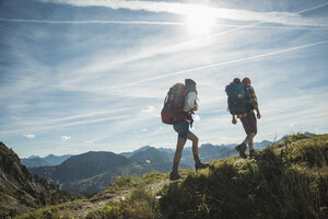 Austria, Tyrol, Tannheimer Tal, young couple hiking on mountain trail - UUF002198