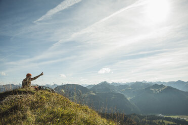 Austria, Tyrol, Tannheimer Tal, young man taking selfie in mountainscape - UUF002195