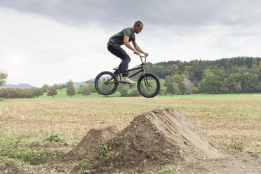 Germany, Freiburg, Young man jumping with BMX bike - DRF001135