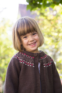 Portrait of smiling little girl wearing brown cardigan - LVF002056